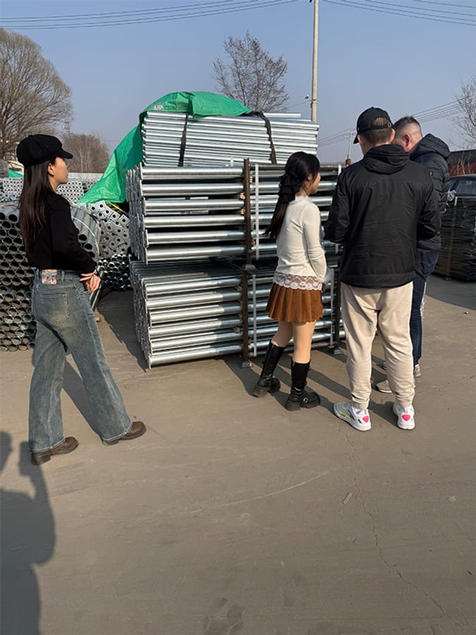 Customers checking scaffolding products and steel pipes at Taihe factory