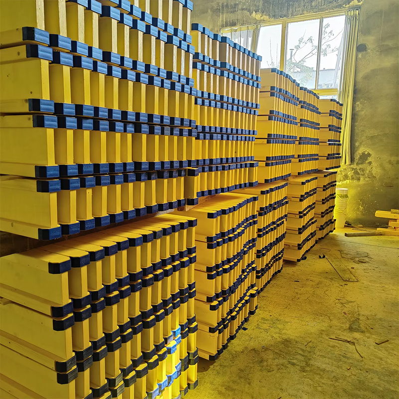 H20 timber beams with blue end caps in factory storage